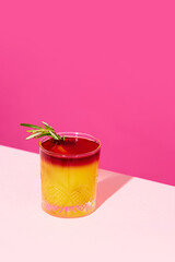 Sour cocktail with orange juice against pink background. New York sour traditional cocktail. Concept of alcohol and non-alcohol drink, party, holidays, bar, mix. Poster. Copy space for ad - obrazy, fototapety, plakaty