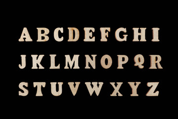 wooden letters of the English alphabet on a black background