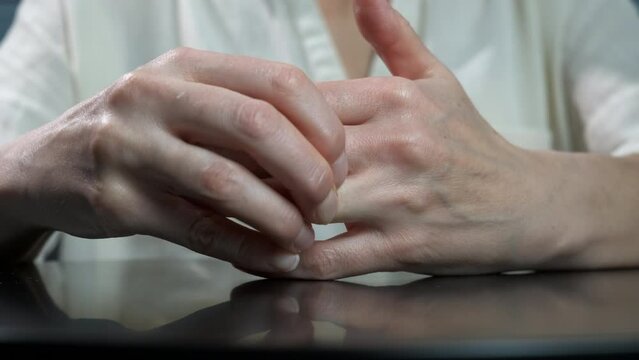 Uncertain remove ring. A depressed woman try to remove the golden ring because of problems with husband.