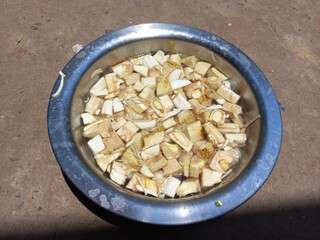Water Dropped cutting jackfruit Vegetable of Aluminum pot,Put small chopped pieces of jackfruit in an aluminium vessel,Raw jackfruit Sliced in water, Cutting Jackfruit pieces in the hand 
