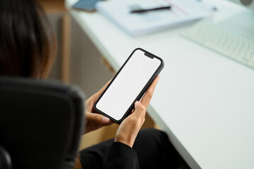 Unrecognizable businesswoman hands holding smartphone with empty screen. Closeup