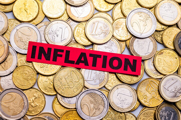 Background of Euro coins, and red ticket with text Inflation.