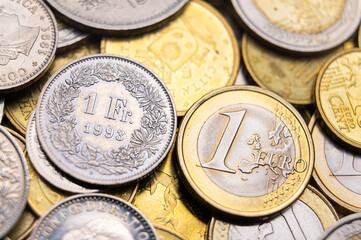 Euro and Swiss Franc coins next to each other, 1 euro and 1 CHF coins