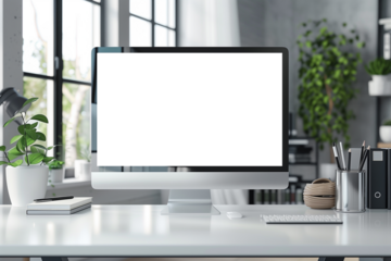 Laptop computer on a table in a modern interior with green plants and sunlight