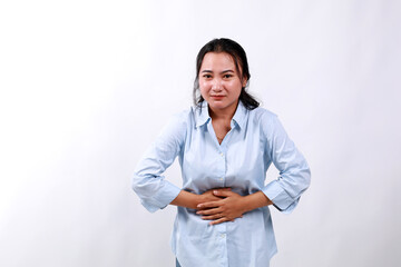 Asian Woman having stomach ache, bending and holding hands on belly, discomfort from menstrual...