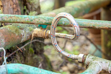 Close-up of metal pipes connected by a hose to prevent leaks.