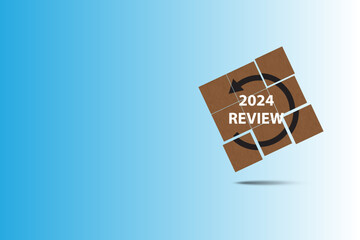 Text REVIEW 2024 in wooden cube. Blue background. Business concept.