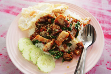 Crispy pork with spicy sauce and fried egg