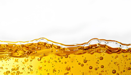Golden yellow oil, closeup of the edge with bubbles floating on top, white background