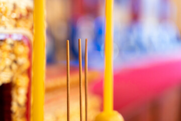 Close-up photo of incense sticks for worship The background uses a blurring technique