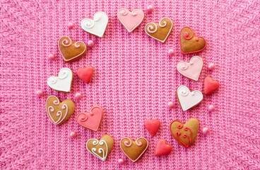 Wedding Invitation Heart-Shaped Cookies in a Symmetrical Arrangement on a Pink knitted Background. Wave Effect Vignette