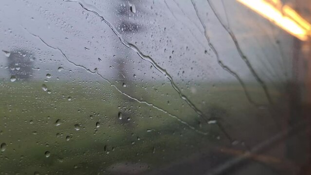rain water drops moving on a high speed train window