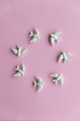 White swallows on pink background