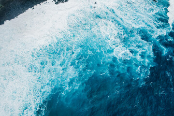 Aerial view of rough ocean with waves and volcanic beach, porto Moniz Madeira, Portugal