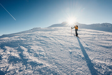 Mountaineer backcountry ski walking ski alpinist in the mountains. Ski touring in alpine landscape...