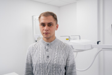 Fototapeta premium in a private clinic in a white x-ray room a patient prepares for a procedure