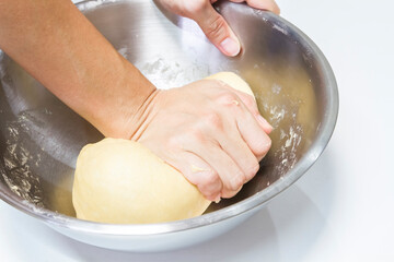 Female hands kneading a dough