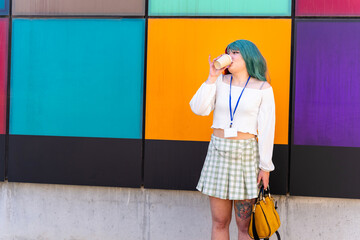 Nerdy girl with badge drinking a takeaway coffee