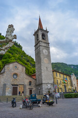 Italy, Varenna, 22.04.2024: Church of Chiesa di Santa Maria delle Grazie against a backdrop of rocks and petrified trees