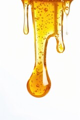 A close-up of a drop of honey dripping from a spoon. Ideal for food and cooking concepts