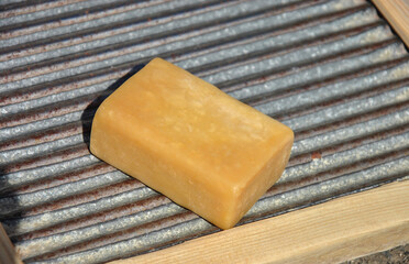 close up of a bar of soap. laundry soap on an old washing board for hand washing close-up. selective focus