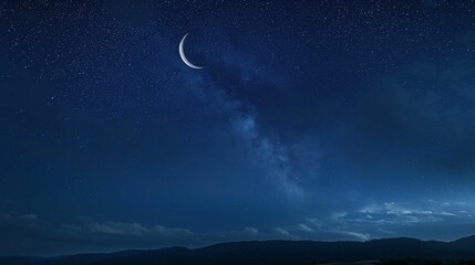 Crescent moon and stars over a night landscape. Night sky photography with celestial theme.