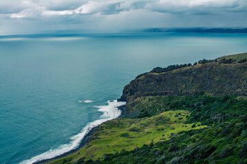 Panoramic view over Te Toto Gorge and Tasman Sea on an overcast summer day. High vantage point. Raglan, New Zealand