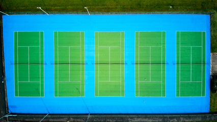 Tennis courts aerial view. Distinct blue and green coloured tennis courts in a line.  