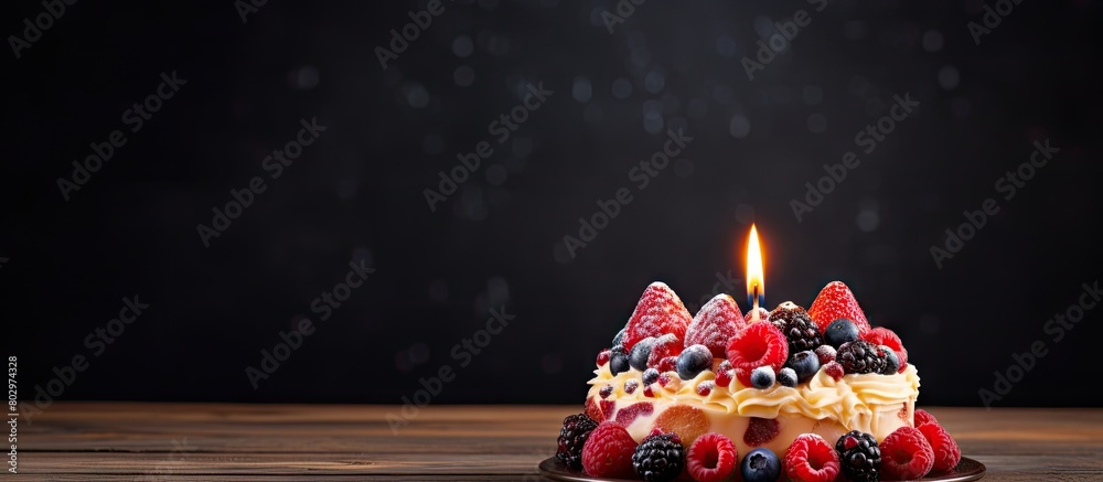 Poster a birthday fruit cake with a single candle creating the perfect still life for a copy space image