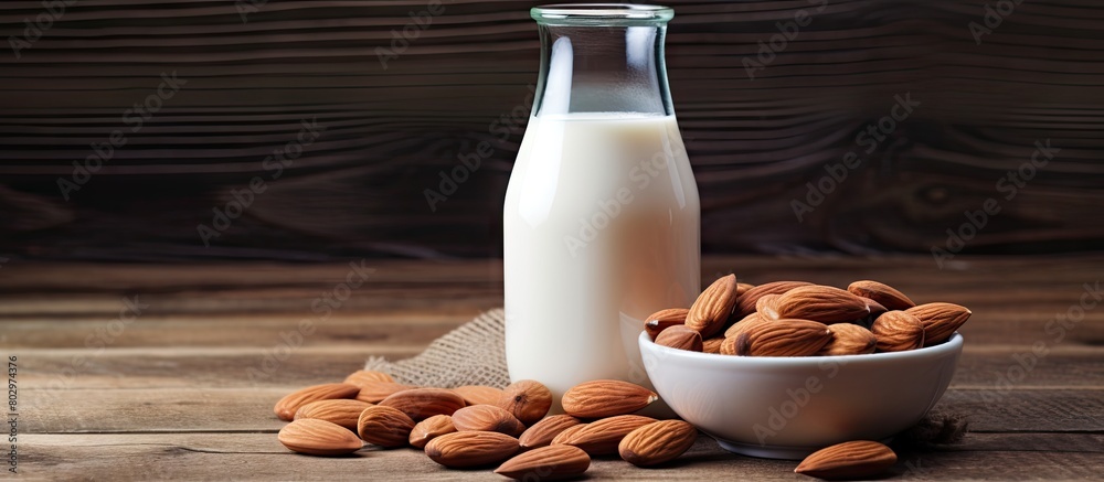 Poster a copy space image of almond milk and almonds displayed on a wooden background