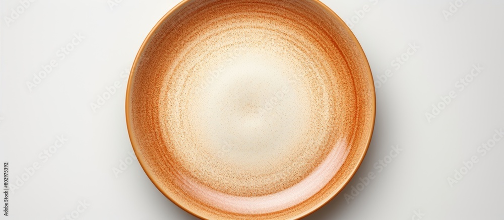 Poster A ceramic plate with a brown circle set on a white background is devoid of any objects with additional space for text or images