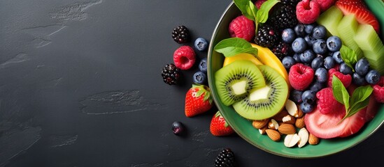 A colorful vibrant smoothie bowl topped with fresh fruits and nuts Perfect for a nutritious and delicious breakfast or snack Copy space image