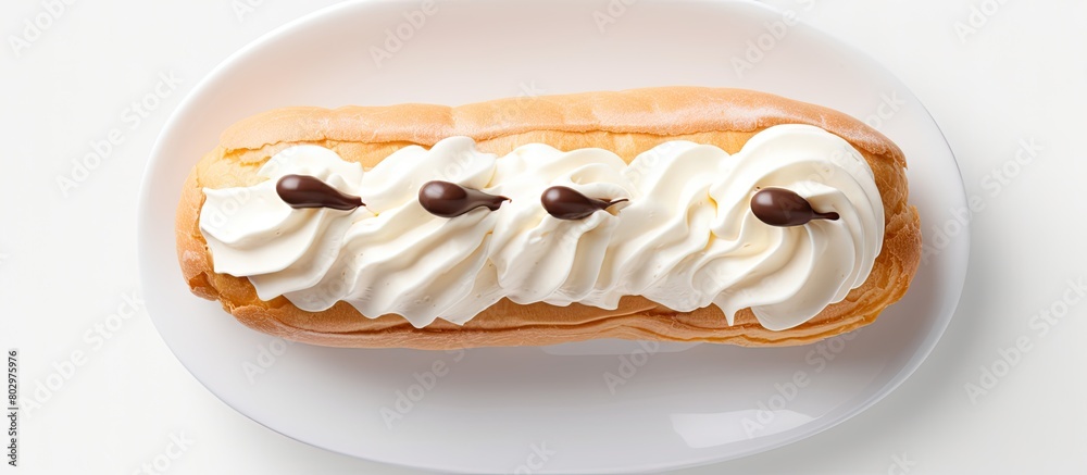 Fototapete a cream filled eclair is seen from above in a photo with ample space for additional elements emphasi