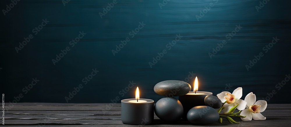 Poster a dark table with burning candles spa stones and ample copy space for text
