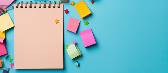 A color background with various stationery items like a notebook pins clips and sticky notes for a visually appealing copy space image