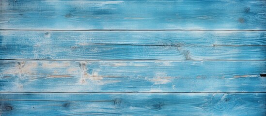 A beautiful background of an old blue wooden board is shown in a front view with copy space The board s vertical direction enhances the design providing a wooden background with traces of old paint