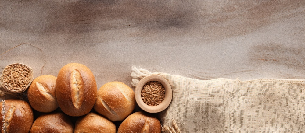Fototapete A copy space image featuring bread rolls and seeds placed on a textured burlap background providing ample white space for adding text