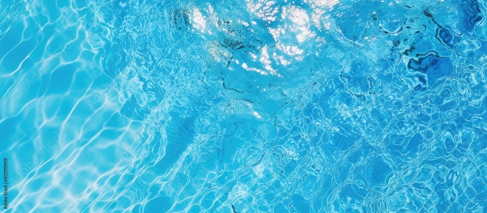 Poster A bright blue swimming pool with a ripple surface is seen from a top view The clear water reflects the sun creating a stunning abstract image that can be used as a texture background or wallpaper The
