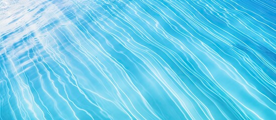A bright blue swimming pool with a ripple surface is seen from a top view The clear water reflects the sun creating a stunning abstract image that can be used as a texture background or wallpaper The