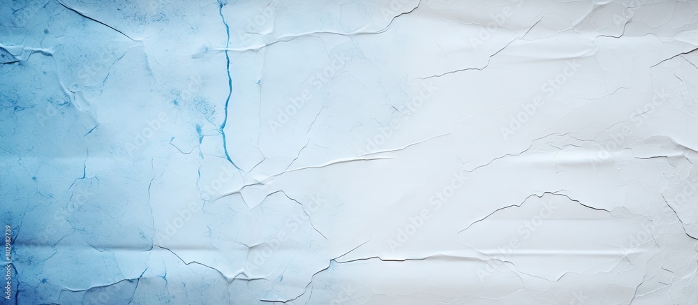Poster A blue paper with torn edges is placed on a white paper background creating a copy space image