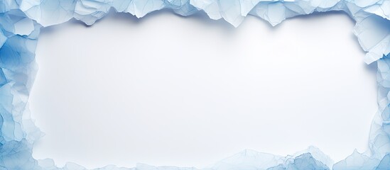 A blue paper with torn edges is placed on a white paper background creating a copy space image