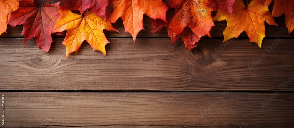 Poster a close up of autumn maple leaves on a wooden background providing copy space for images