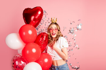Fototapeta premium Photo portrait of lovely young woman balloons crown confetti dressed stylish white garment hairdo isolated on pink color background