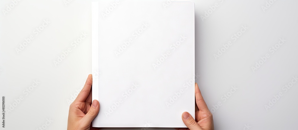 Poster A copy space image of a white background featuring a person holding a blank notebook