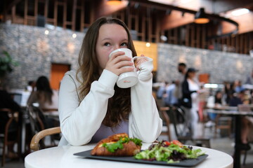 Beautiful girl with a white cup of coffee