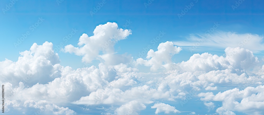 Poster a copy space image with a backdrop of a clear blue sky dotted with fluffy white clouds