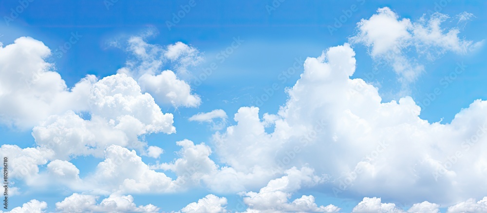 Poster a copy space image with a backdrop of a clear blue sky dotted with fluffy white clouds