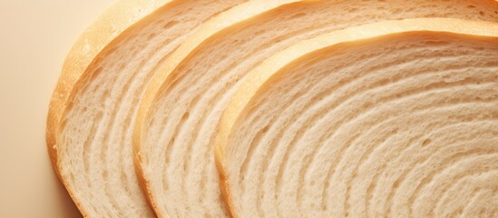 Fototapeta premium A close up top view of a beautiful big sliced bread on a cream color background perfect for design with copy space image