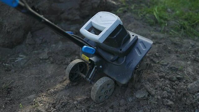 Gasoline cultivator. Motoblock plowing the land with a plow. High quality FullHD footage