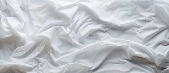 Obraz premium A crumpled white paper with creases forms the backdrop creating a textured grunge image with copy space